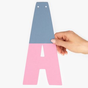 Hand Holding Two Tone Letter From Large Custom Party Banner Decoration With Personalised Message